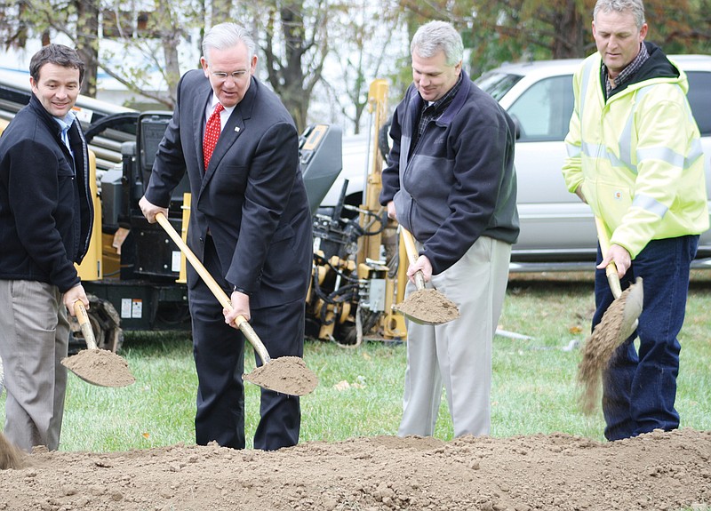 Missouri Gov. Jay Nixon, second from left, joins a groundbreaking ceremony Wednesday outside the Millersburg Christian Church of the start of Socket Telecom's construction of a fiber optic broadband network in Callaway County. With the governor, from left, are Joe Ridenhour of Ridenhour Construction Co. of Jefferson City; George Pfenenger, Socket chief executive officer; and Carson Coffman, Socket president.