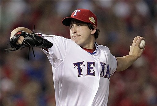 Texas Rangers starting pitcher Derek Holland throws during the first inning of Game 4 of baseball's World Series against the St. Louis Cardinals Sunday, Oct. 23, 2011, in Arlington, Texas. The Rangers won the contest, evening the series at 2 games apiece.