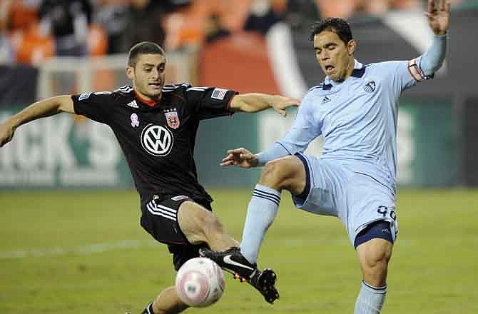 D.C. United defender Chris Korb, left, battles for the ball against Sporting Kansas City's Omar Bravo, right, during the first half of an MLS soccer game, Saturday, Oct. 22, in Washington, D.C.