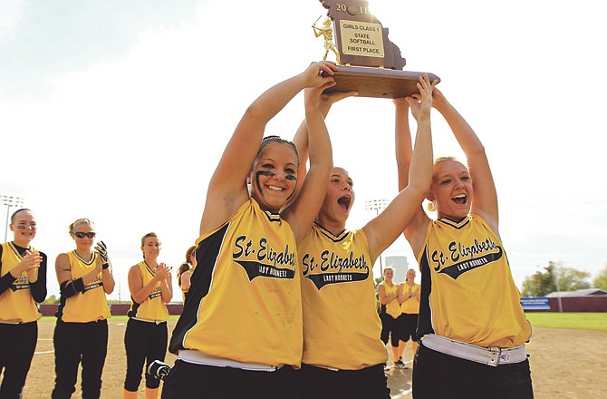 Members of the St. Elizabeth Hornets hold up the state softball championship trophy after defeating the Jefferson Eagles to become the Class 1 State Champions.