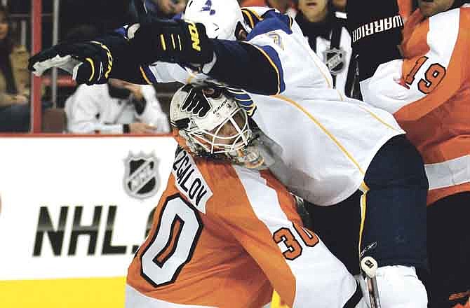 Saint Louis Blues' Jason Arnott collides with Philadelphia Flyers goalie Ilya Bryzgalov during the first period of an NHL hockey game, Saturday, Oct. 22, 2011, in Philadelphia. No penalty was called.