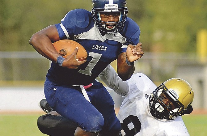 Lincoln quarterback Percy Turner breaks a tackle while scrambling from the pocket during Saturday afternoon's matchup with Emporia State at Dwight T. Reed Stadium in Jefferson City.