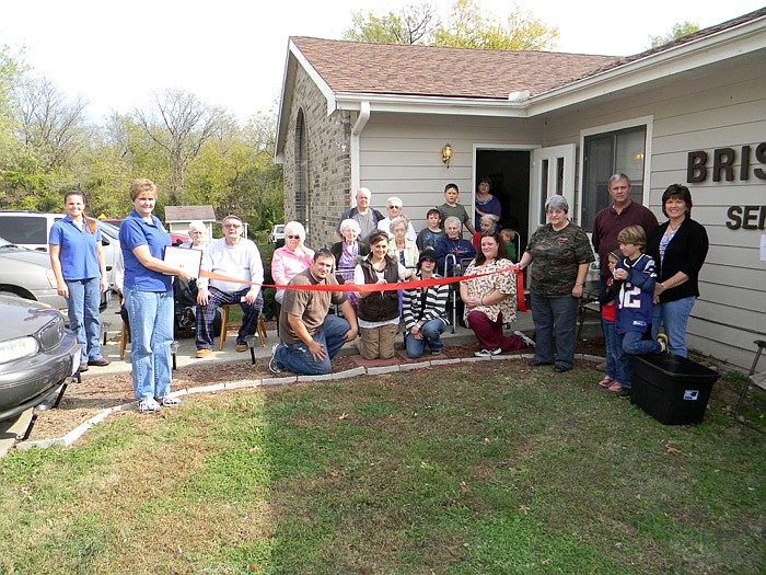 Members of the California Area Chamber of Commerce, family, friends and residents of Bristol Manor help new Bristol Manor Manager Kayci Porter cut the ribbon.