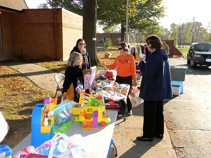 Residents of California as well as the care center look through rummage items to purchase.