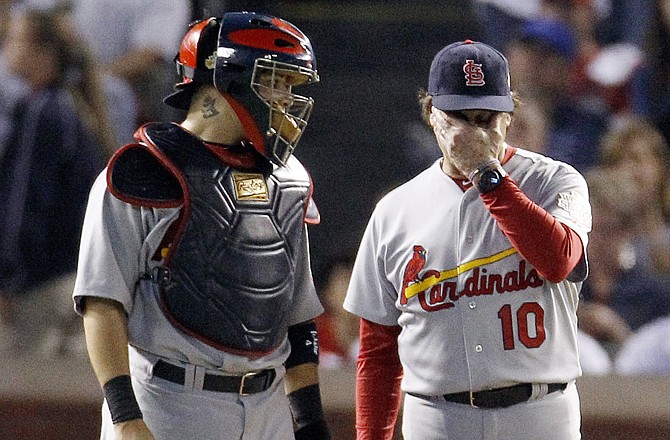 Cardinals catcher Yadier Molina and manager Tony La Russa wait for reliever Jason Motte to enter in the eighth inning of Monday night's game against the Rangers in Arlington, Texas. There was confusion between the Cardinals' dugout and bullpen in the inning.
