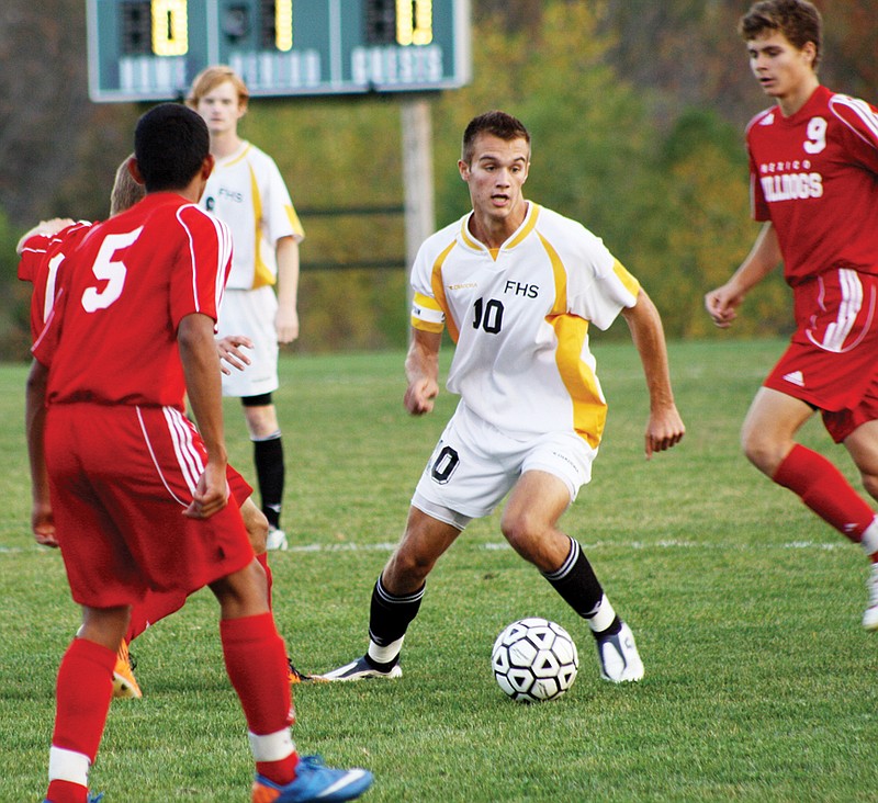 Fulton senior Jake Pierce tries to maneuver the ball between a trio of Mexico players in the first half of the Hornets' 2-0 victory over the rival Bulldogs on Tuesday night at the high school athletic complex. Fulton secured a share of the NCMC championship with its win.