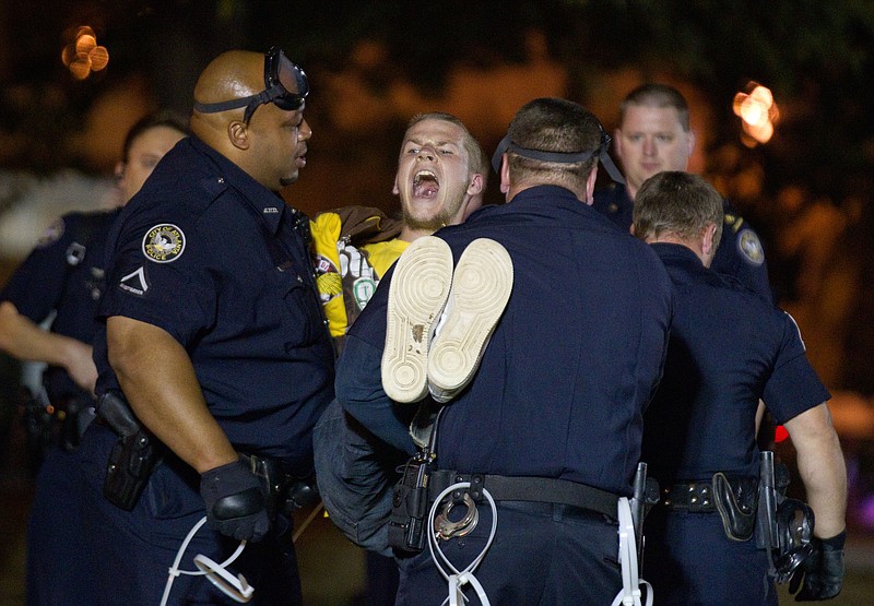 A protestor of the Occupy Atlanta demonstration is arrested after refusing to leave after Mayor Kasim Reed revoked his executive order allowing the protestors to camp out in Woodruff Park on Wednesday in Atlanta.