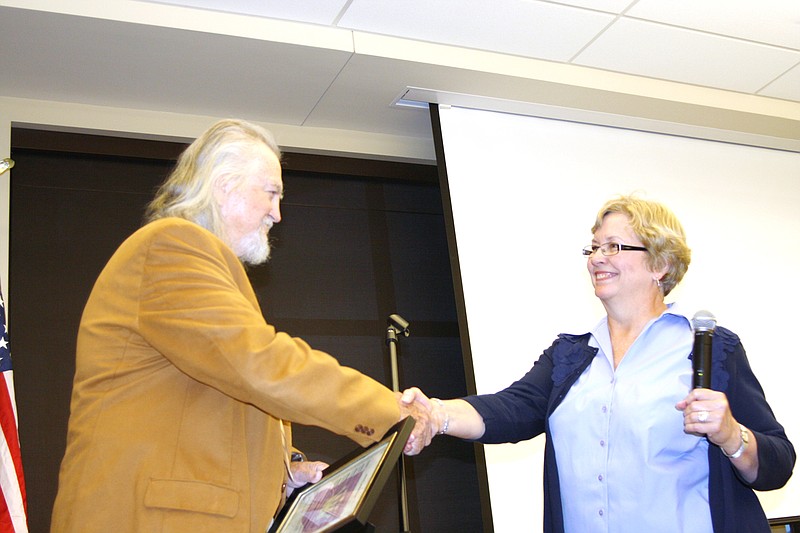 Kingdom of Callaway Historical Society President Susan Krumm presents Paul Johnson with a proclamation naming him an Honorary Callawegian for his work on mapping - and identifying the persons buried in - area cemeteries during the society's annual meeting Thursday night. Also during the meeting, Bruce Hackmann, Paul Johnson, Mike Auer, Frances Vaughn and Esther Digh were named to the Board of Directors. Named as officers for 2012 were: Susan Krumm, president, David Gilman, vice president, Esther Digh, secretary and Frances Vaughn, treasurer.