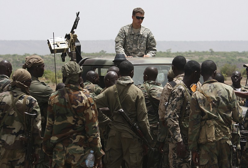 Malian special forces listen to instructions in May 2010 from a U.S. special forces soldier on counter-ambush tactics in Kita, Mali, during a joint training exercise. While putting few U.S. troops at risk, the United States is providing intelligence and training to fight militants across the continent, from Mauritania in the west along the Atlantic Ocean, to Somalia in the east along the Indian Ocean. 