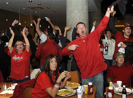 St. Louis Cardinals fan Clint Johnston, center standing, reacts while watching a broadcast of Game 7 of baseball's World Series between the Cardinals and the Texas Rangers on Friday, Oct. 28, 2011, in St. Louis. 