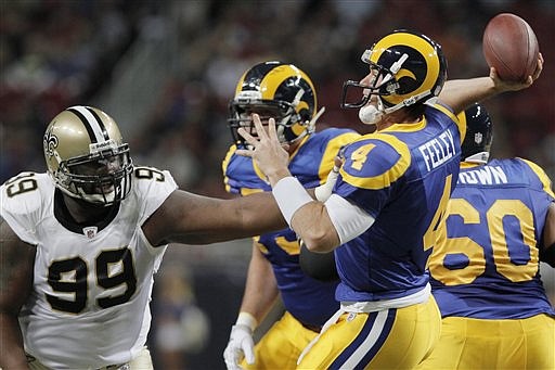 St. Louis Rams quarterback A.J. Feeley (4) throws under pressure from New Orleans Saints' Aubrayo Franklin (99) during the first quarter of an NFL football game Sunday, Oct. 30, 2011, in St. Louis. 