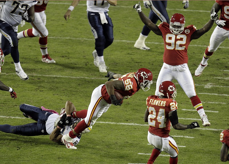 Chiefs linebacker Derrick Johnson is pulled down by Chargers receiver Vincent Jackson after an interception Monday night at Arrowhead Stadium. Watching are Wallace Gilberry (92) and Brandon Flowers (24) of the Chiefs.