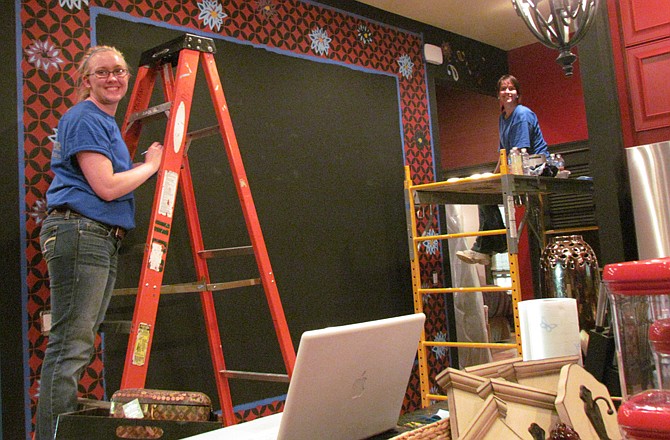 Erica Gaw, above left, works with a friend in one of the Extreme Makeover homes in Joplin. 