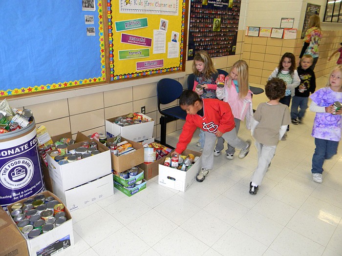 Students in Lauren Novak's kindergarten class donate cans to the Food Bank for Central and Northeast Missouri as part of Red Ribbon Week.