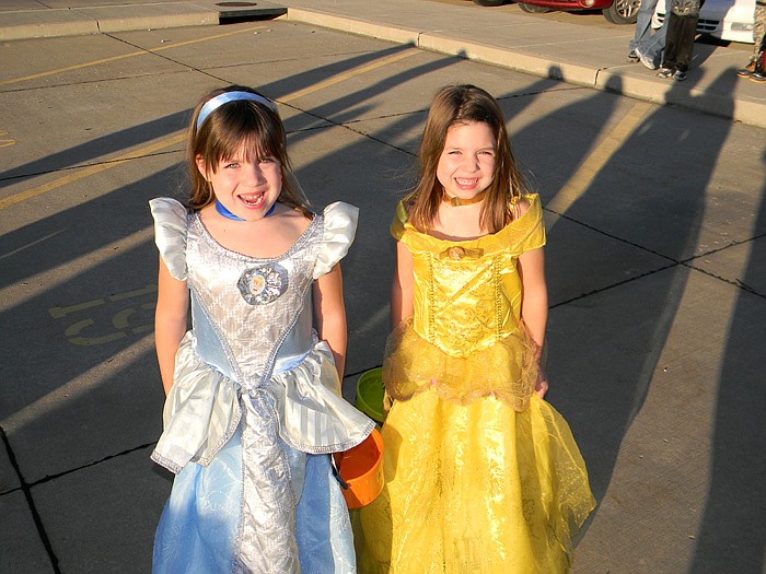 Emily, left, and Allison Theissen, right, dressed as "Cinderella" and "Belle."