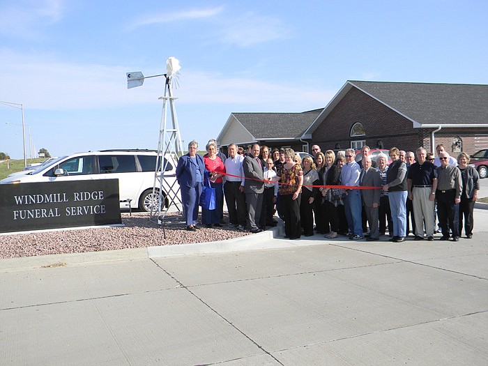 Members of the California Area Chamber of Commerce, family, friends and employees of Windmill Ridge Funeral Services help Owners Brian and Stephanie Hufendiek cut the ribbon on their new business.
