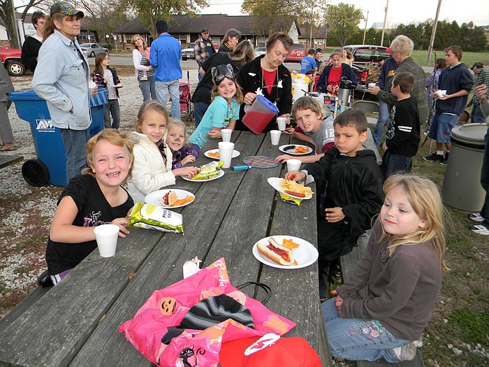 Children enjoy hot dogs, chili and chips at the Living Faith Assembly of God, Russellville, Fall Festival held Sunday, Oct. 30.