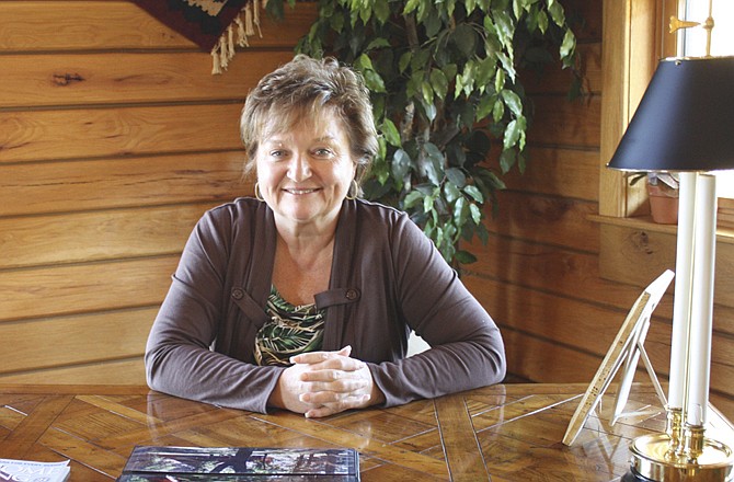 Lynn Gastineau sits in her Gastineau Log Homes display home just south of New Bloomfield. The company signed a deal last week to export homes to China.