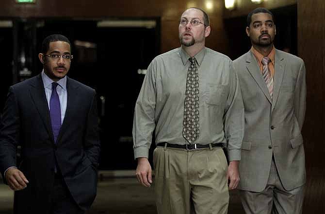 Christopher Chaney, 35, of Jacksonville, Fla., center, his attorneys Chris Chestnut, left, and Jamon Hicks arrive for a news conference in Los Angeles, Tuesday, Nov. 1, 2011. Chaney pleaded not guilty Tuesday to hacking into the email accounts of celebrities such as Christina Aguilera, Mila Kunis and Scarlett Johansson, whose nude photos eventually landed on the Internet.