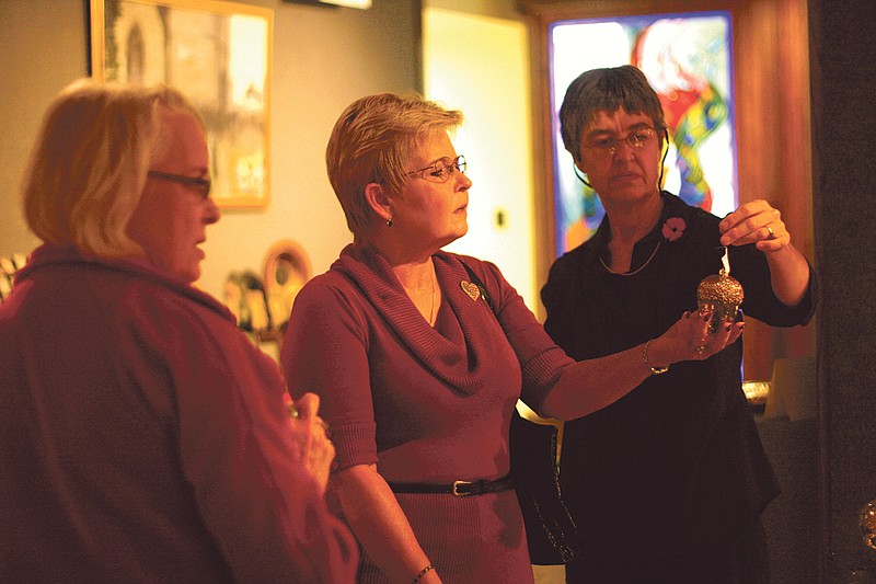 Westminster's president's wife Jane Forsythe, center, looks at ornaments at the Churchill Memorial Victorian Christmas in 2010 with Michele Bowmaster, of Fulton, and Victoria Quinault.