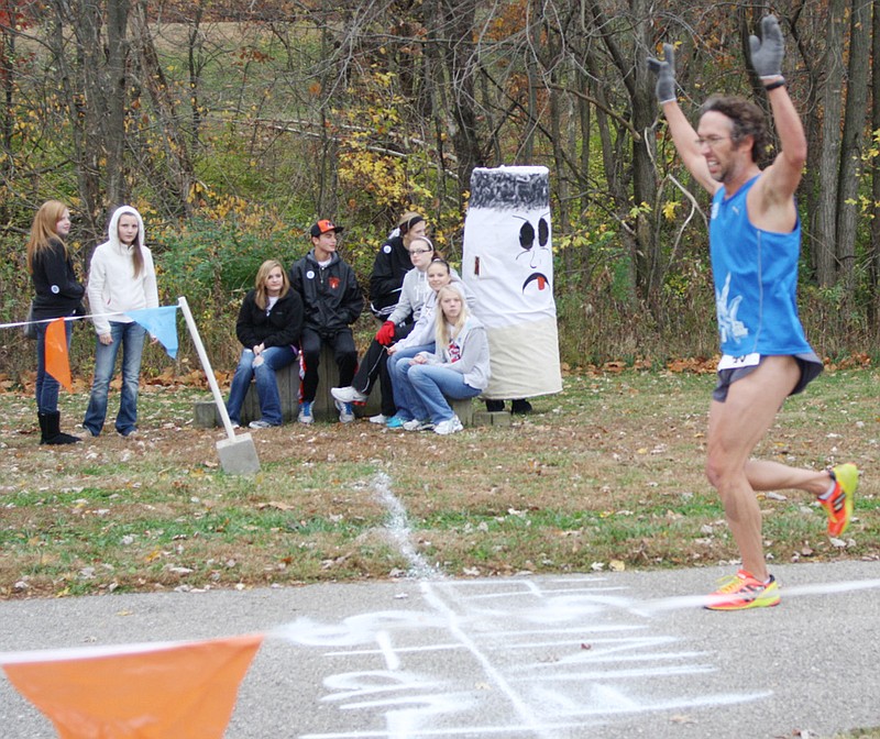 Tony Rigdon of Columbia crosses the finish line Saturday to win the New Bloomfield School Smokebusters Kick Butts 5K Run/Walk race Saturday along the Stinson Creek Trail in Fulton.