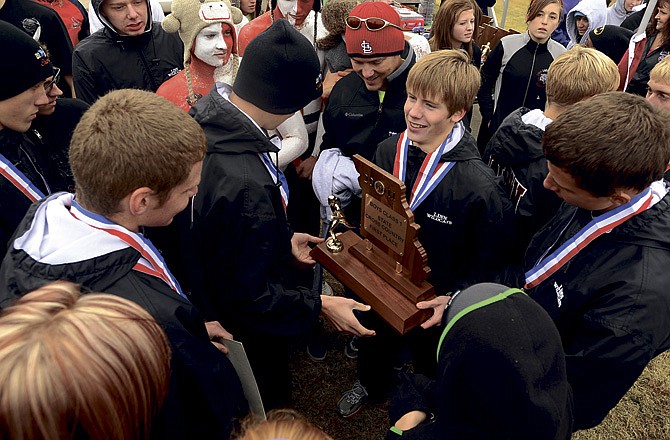 Linn senior and individual state champion Kaleb Wilson shows off Linn's trophy after the school claimed the top cross country spot for boys Class 1. For more, see our newspaper or e-Edition for Sunday, Nov. 6, 2011. 