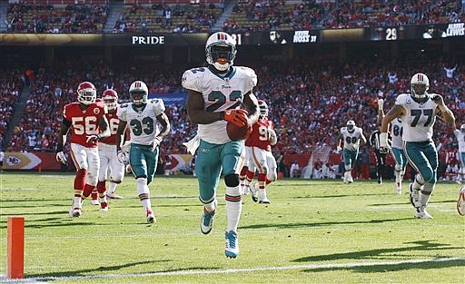 Miami Dolphins running back Reggie Bush (22) crosses the goal line for a touchdown during the second half of an NFL football game against the Kansas City Chiefs in Kansas City, Mo., on Sunday, Nov. 6, 2011. 