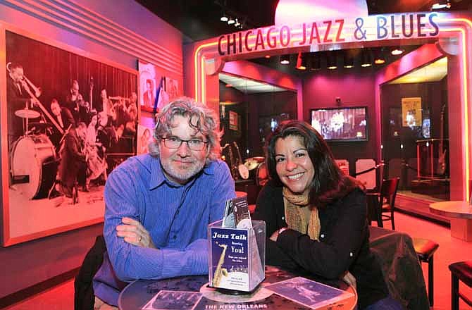 In this photo taken Oct. 24, 2011, Kelly Leonard, left, vice-president at the Second City comedy club and Liz Garibay with the Chicago History Museum, sit within a display highlighting Chicago's Jazz and Blues history at the museum in Chicago. Second City, famed for its parody and improvisation, has partnered with the museum to turns its wit on Chicago itself. 