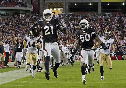 Arizona Cardinals' Patrick Peterson returns a punt 99 yards for a touchdown to beat the St. Louis Rams, in overtime of an NFL football game Sunday, Nov. 6, 2011, in Glendale, Ariz. The Cardinals won 19-13. (AP Photo/The Arizona Republic, David Kadlubowski)
