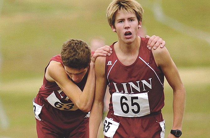 Tyler Rush leans on Linn teammate Kaleb Wilson after the two finished 1-2 Saturday morning in the Class 1 boys Cross Country Championships at the Oak Hills Golf Center in Jefferson City.