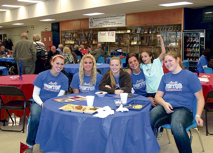 Lady Pinto basketball players are among those enjoying the meal at the annual Lady Pinto Hog Roast Sunday at the high school to show support for the Lady Pinto basketball teams.