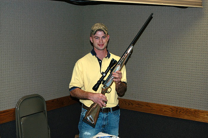 Andrew Sommerer, president of the Moniteau County Chapter of Ducks Unlimited, displays a Mossberg .270 caliber rifle with scope which was the prize in a drawing.
