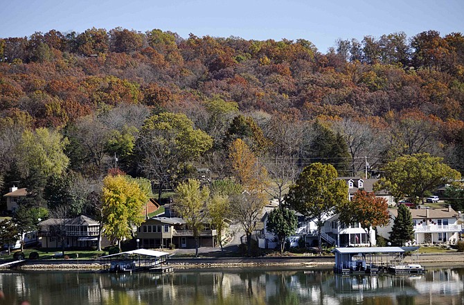 A dock floats anchored behind a Mid-Missouri lakefront home on the Lake of the Ozarks near Camdenton.