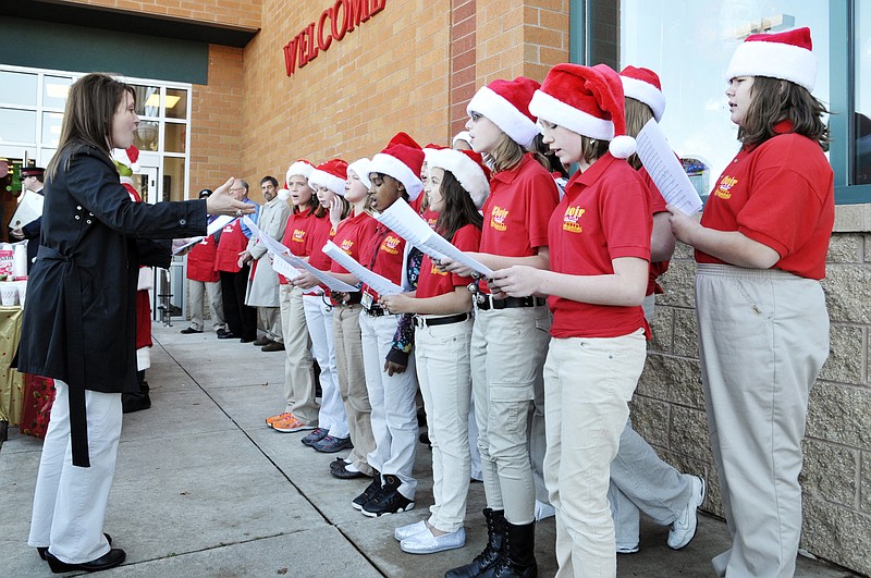 Leann Meyer directs singers from Lewis and Clark Middle School's Girls Ensemble during Friday's Salvation Army Tree of Lights Campaign Kickoff. 