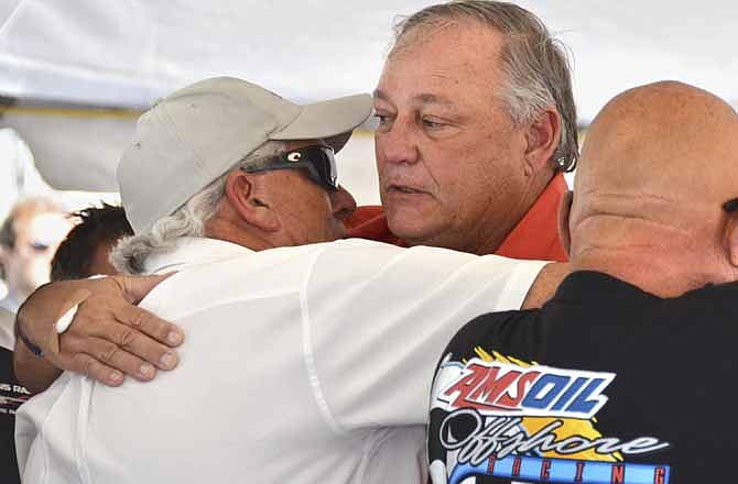 Stephen Page, center, is consoled at a memorial service for the loss of his racing teammate, Joey Gratton, Saturday, Nov. 12, 2011, in Key West, Fla. On Friday, Nov. 11, Page and Gratton rolled over in their powerboat during the Key West World Championship. Page survived the accident with minor physical injuries, but Gratton died after being airlifted to a Miami trauma center, marking the third death from the event.