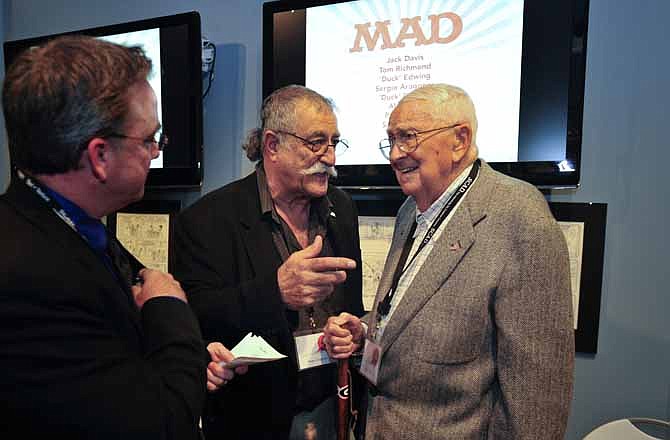 Mad Magazine cartoonist Sergio Aragones, center,and Jack Davis, right, speak Savannah College of Art and Design sequential art chair Anthony J. Fisher, left, at an event in their honor, Friday, Oct. 11, 2011 in Savannah, Ga. Aragones and Davis are among eight veteran MAD contributors gathering Saturday for a rare reunion.