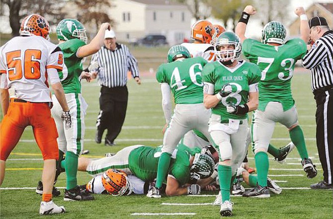 Blair Oaks defensive back Tanner Kemna (8), celebrates after the Falcons recover a fumble during the fourth quarter of Saturday's Class 2 quarterfinal game against Macon in Wardsville. Blair Oaks won the game 27-14. 