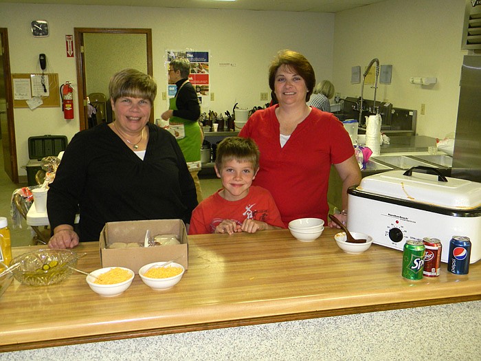 Debbie Yard, left, Tristan Jones, middle, and Belinda Jones, right, helped pass out chili, soup and hot dogs.