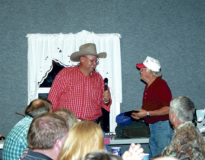 From left, Moniteau County Cattleman's Association President Blue Geier presents a plaque to Don Osborn, California, who was honored as Cattleman of the Year at the Cattleman's Association annual dinner and auction Nov. 8 at Centennial Hall.