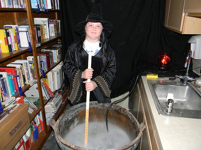 Abby Harris stirs up a witches brew at the High Point School Carnival Haunted House.