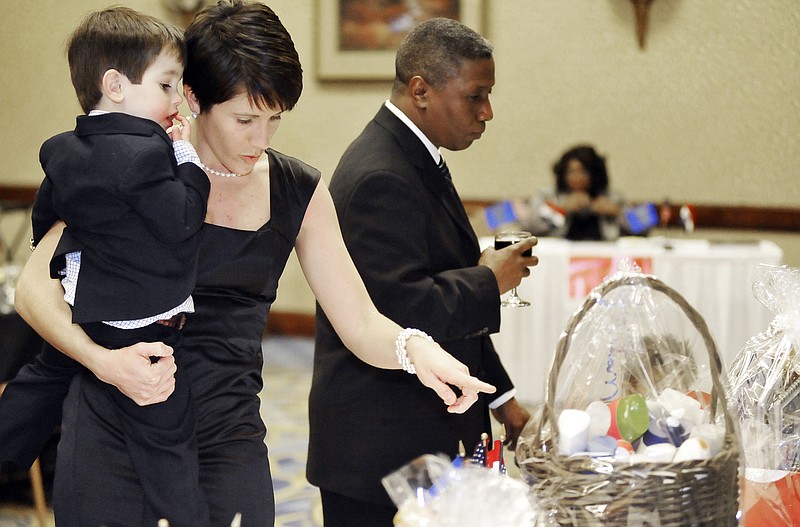 Jane and Atticus Barnes look at a basket from Unilever in the silent auction Friday at the Freedom Fund Dinner for the NAACP at the Capitol Plaza Hotel. Jay Barnes was awarded the Myrtle Smith Oden Young Adult Service Award.