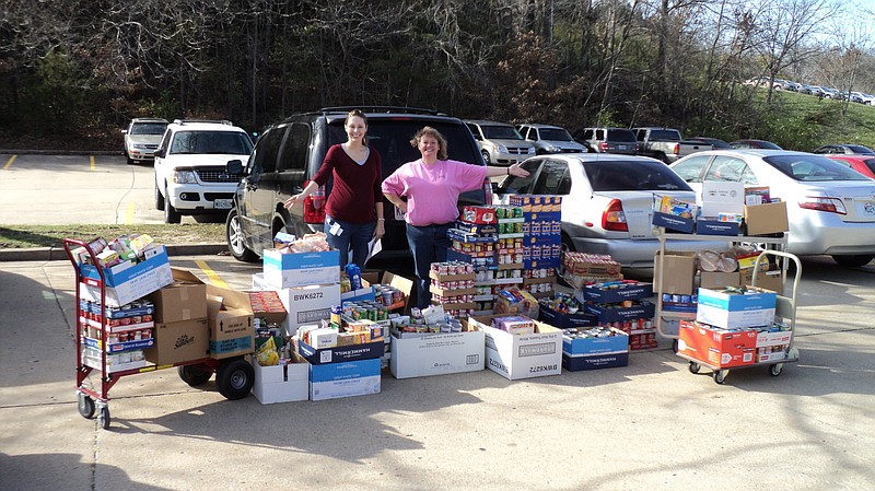 DNR employees stand with donated food items for the Samaritan Center on East McCarty Street.