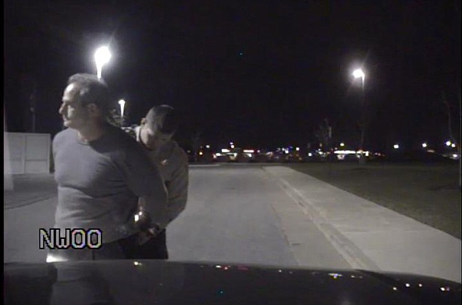 This screenshot from Boone County Sheriff's Department dashboard cam video shows Missouri head football coach Gary Pinkel being arrested and handcuffed on suspicion of DWI on Wednesday night. He pleaded guilty to the misdemeanor charge on Friday.