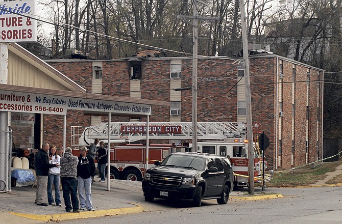 Fire crews and investigators work Saturday at the scene of an early morning fire that gutted an apartment complex at the corner of Dunklin and Mulberry streets in Jefferson City.