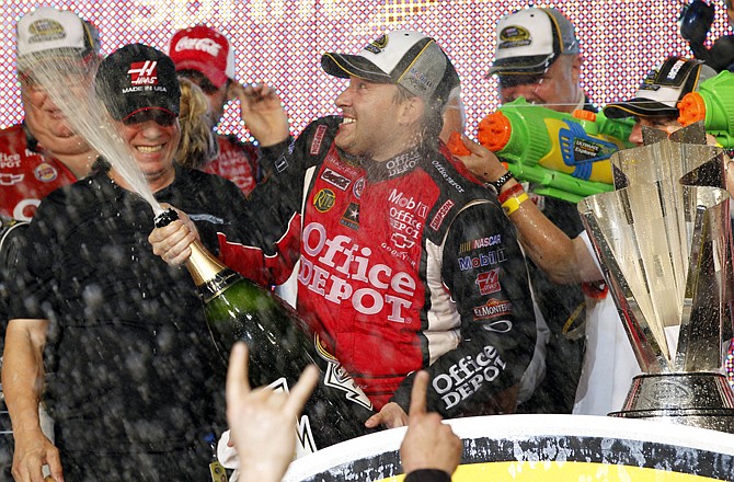 Tony Stewart celebrates after his victory in Sunday's season-ending race at Homestead-Miami Speedway in Homestead, Fla., clinched the title.