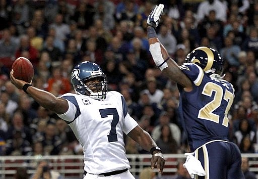 Seattle Seahawks quarterback Tarvaris Jackson throws under pressure from St. Louis Rams safety Quintin Mikell, right, during the first quarter of an NFL football game, Sunday, Nov. 20, 2011, in St. Louis.