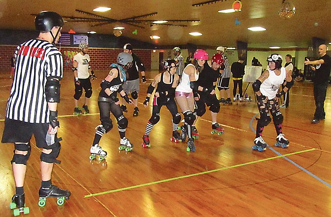 Skaters jostle for position during a roller derby bout at Sunday's Beat Me Halfway Roller Derby Boot Camp at Sk8 Zone.