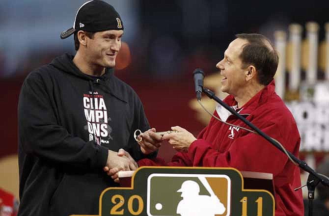 World Series MVP David Freese, left, is given a key to the city by St. Louis Mayor Francis Slay during a celebration in honor of the baseball team's World Series title, Sunday, Oct. 30, 2011, in St. Louis. The Cardinals defeated the Texas Rangers for their 11th series win. 
