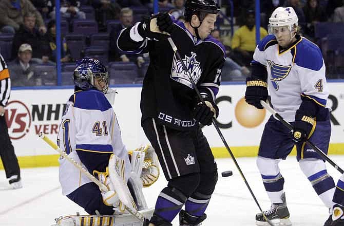 Los Angeles Kings' Colin Fraser (24) tries to redirect the puck past St. Louis Blues goalie Jaroslav Halak (41) during the first period of an NHL hockey game, Tuesday, Nov. 22, 2011, in St. Louis.