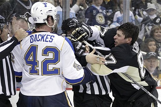 Pittsburgh Penguins' Sidney Crosby, right, is separated from St. Louis Blues' David Backes (42) during the second period of an NHL hockey game in Pittsburgh on Wednesday, Nov. 23, 2011. Both players were penalized.